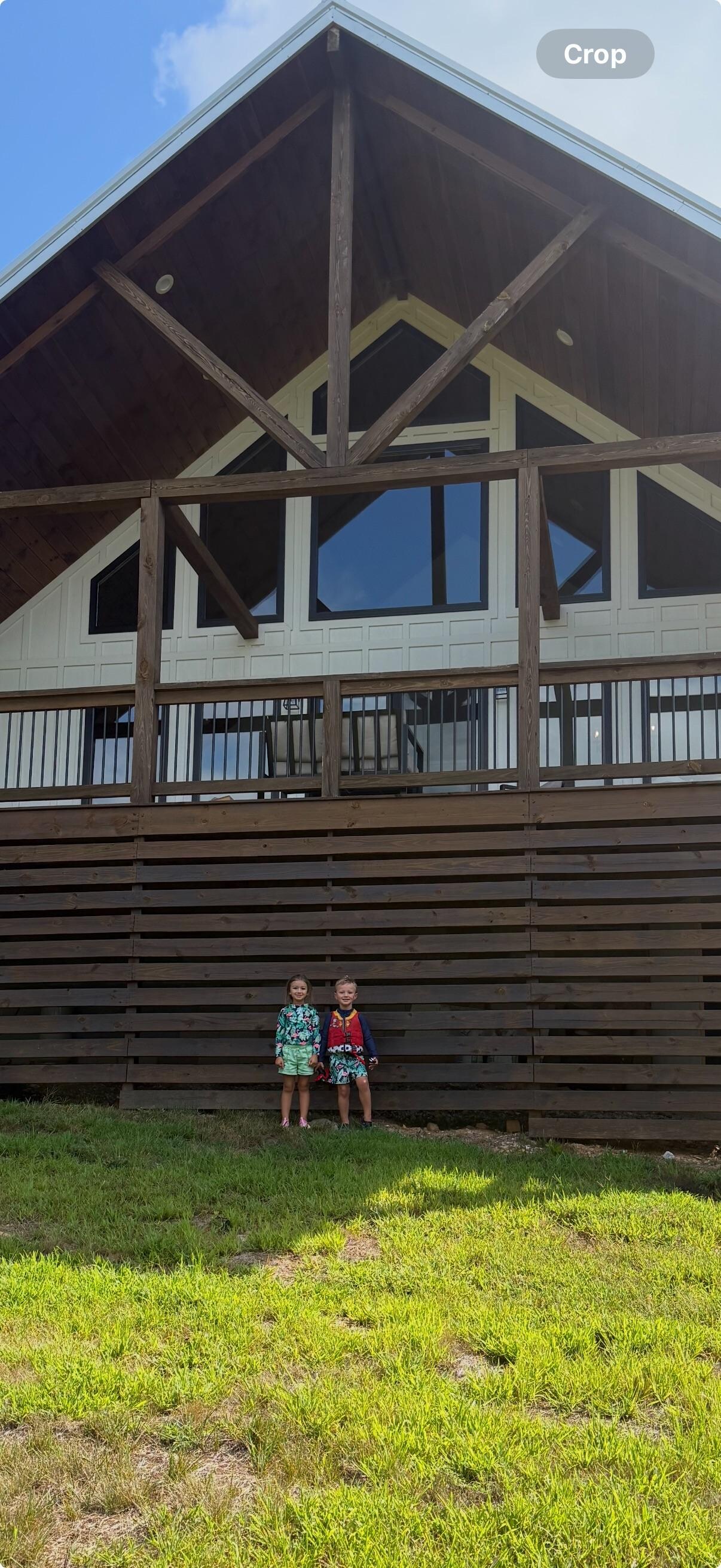 Grand babies in front of house!