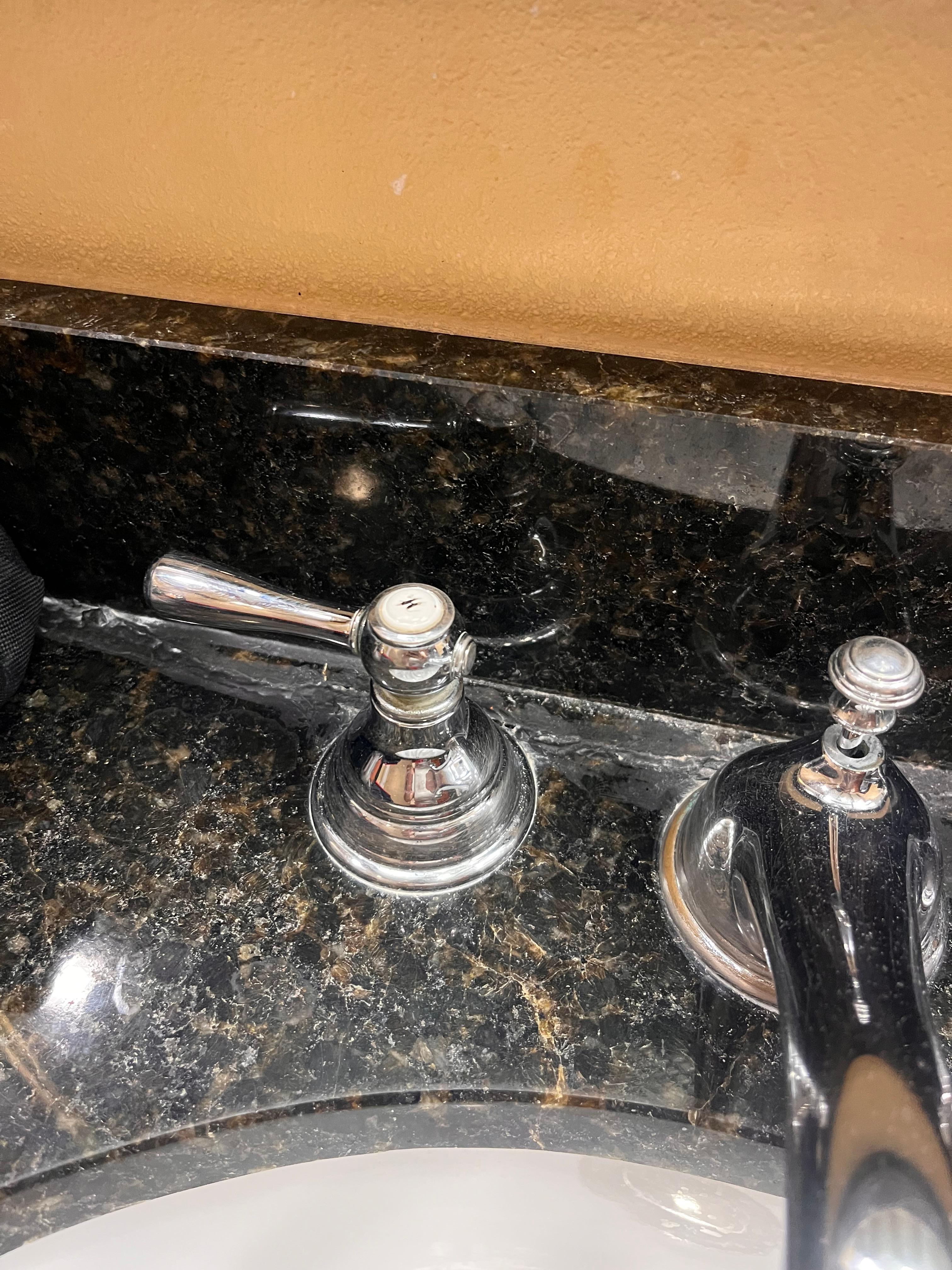 Layers of caulk on bathroom counter. 