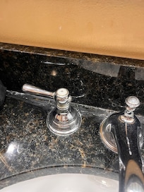 Layers of caulk on bathroom counter.