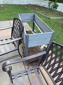 Flower box rotted out and laying next to patio table
