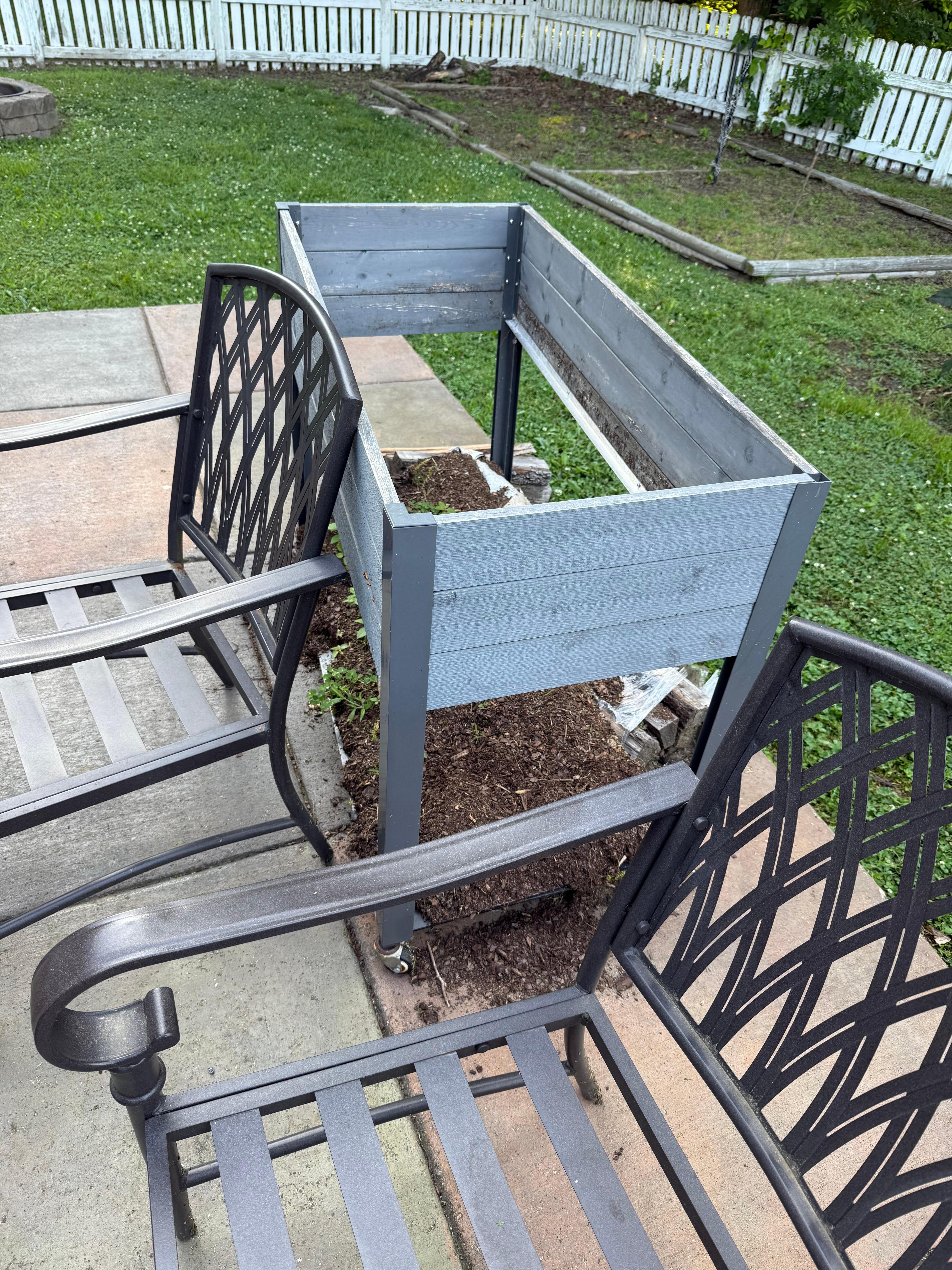Flower box rotted out and laying next to patio table