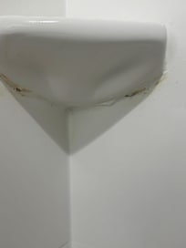 Under the soap dish