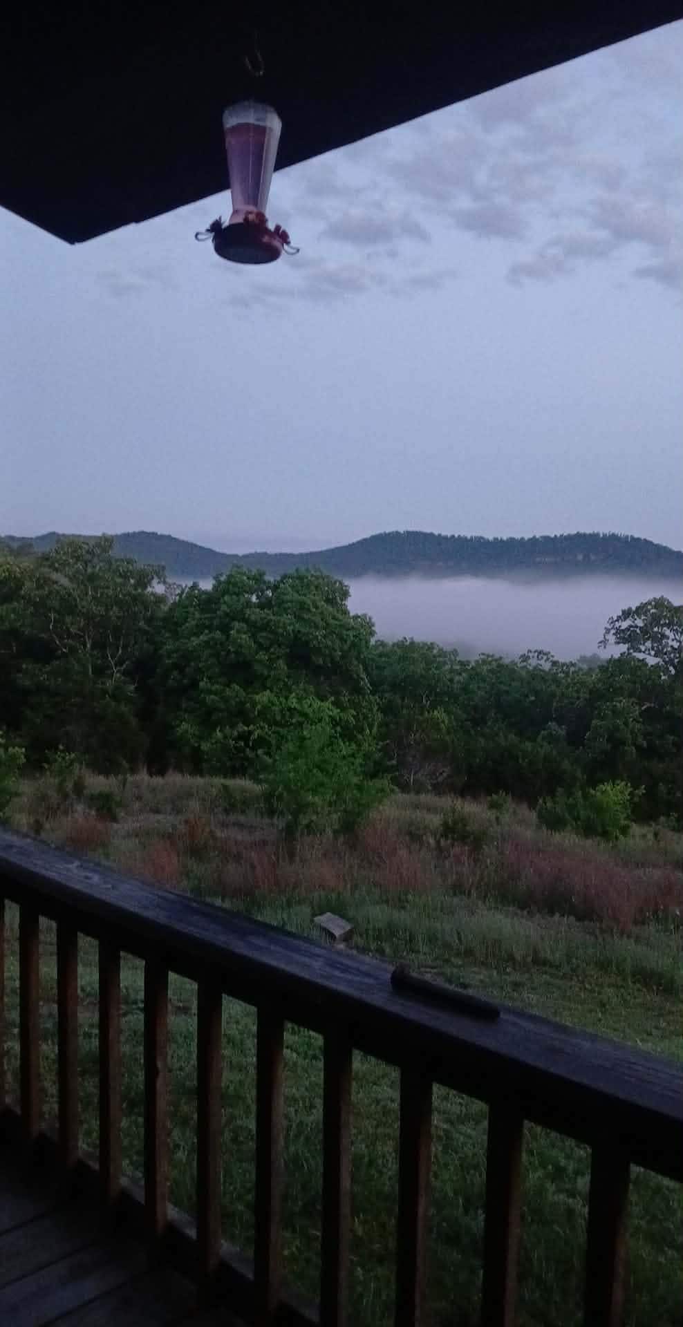 Morning fog lifting from the river below the cabin