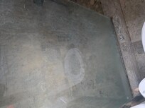 Master shower door covered in soap scum and hard water.