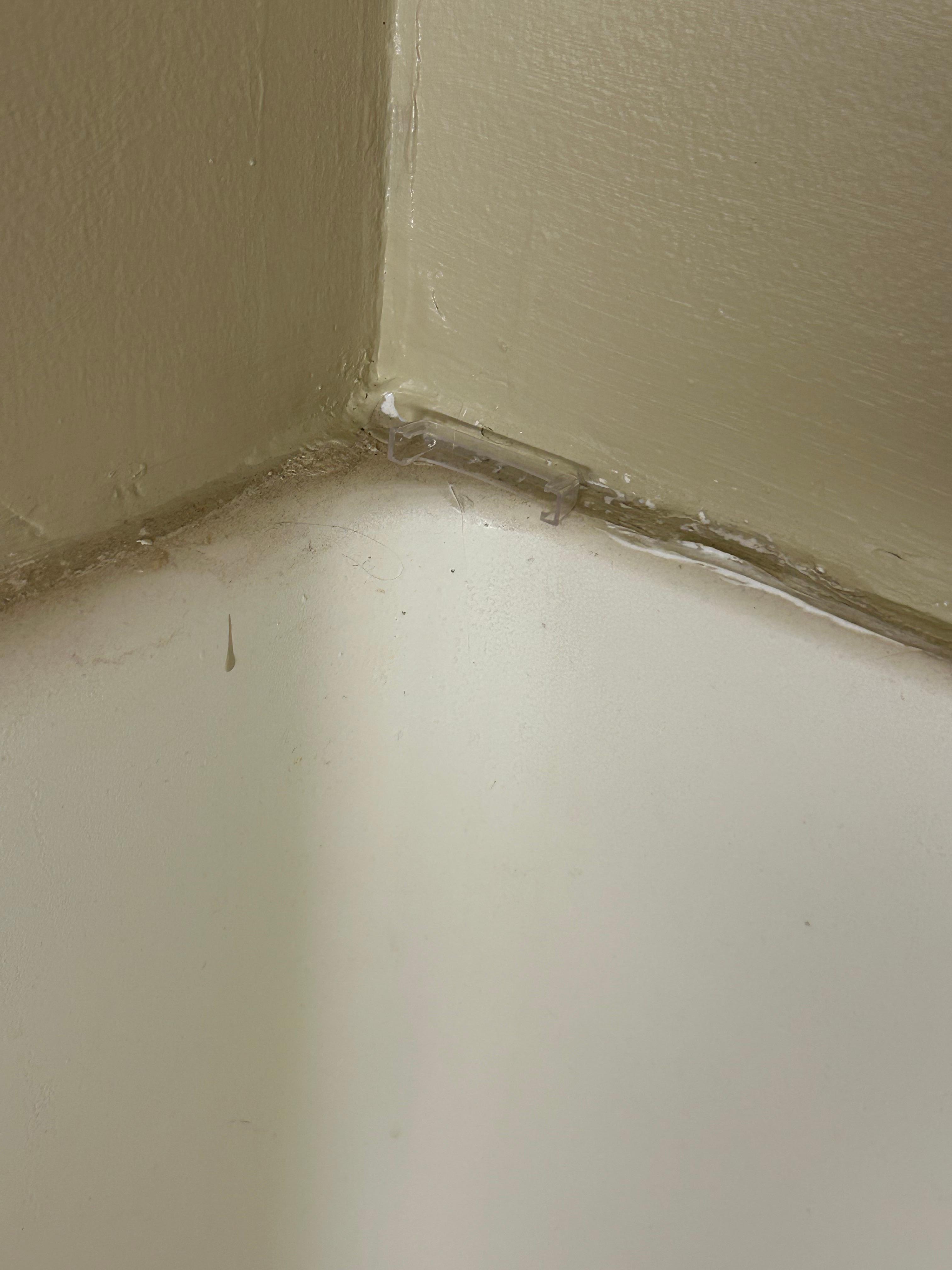 The top of the shower. Covered in dust and an empty razor cover