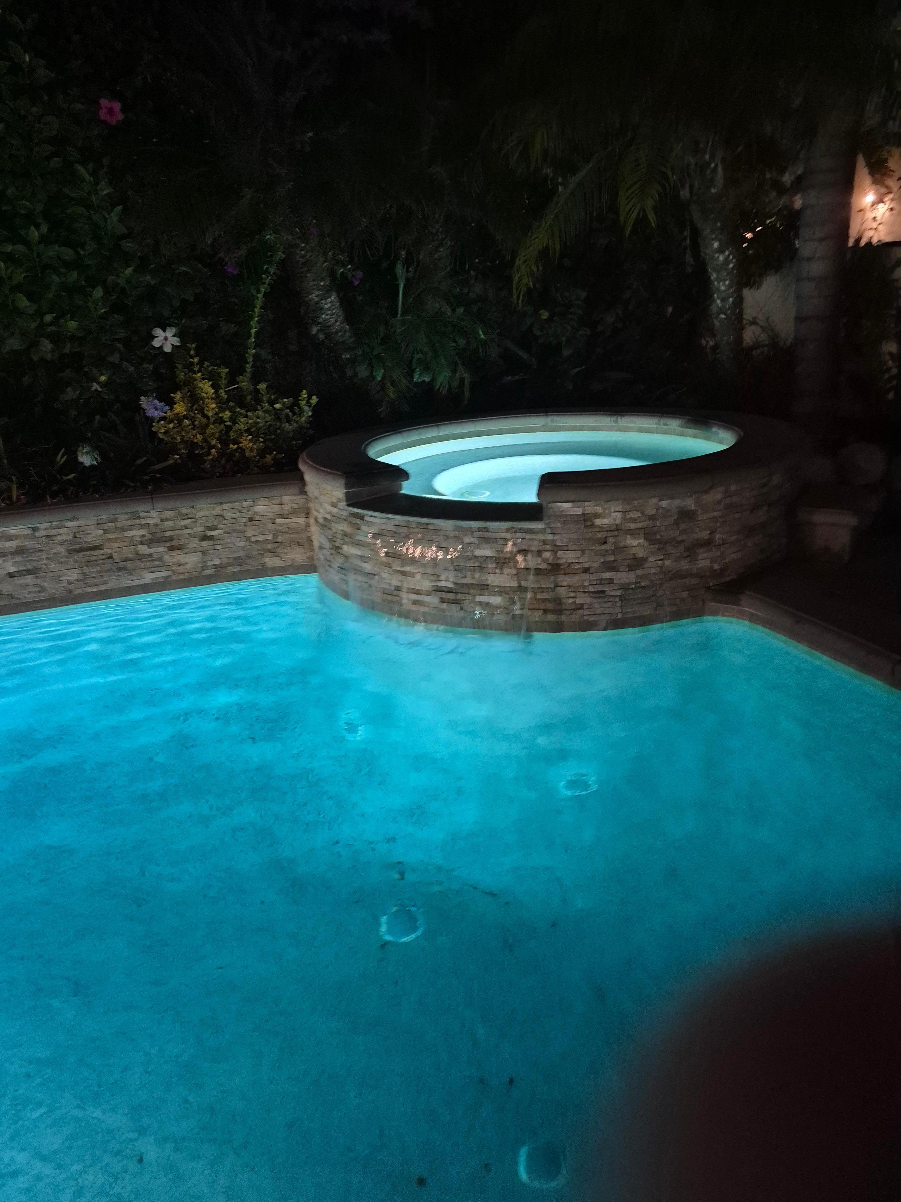 Jacuzzi and pool at night