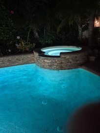 Jacuzzi and pool at night