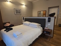 Bed faces ceiling tall windows and open to Repubblica Square