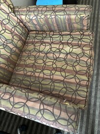 Torn and outdated chair.