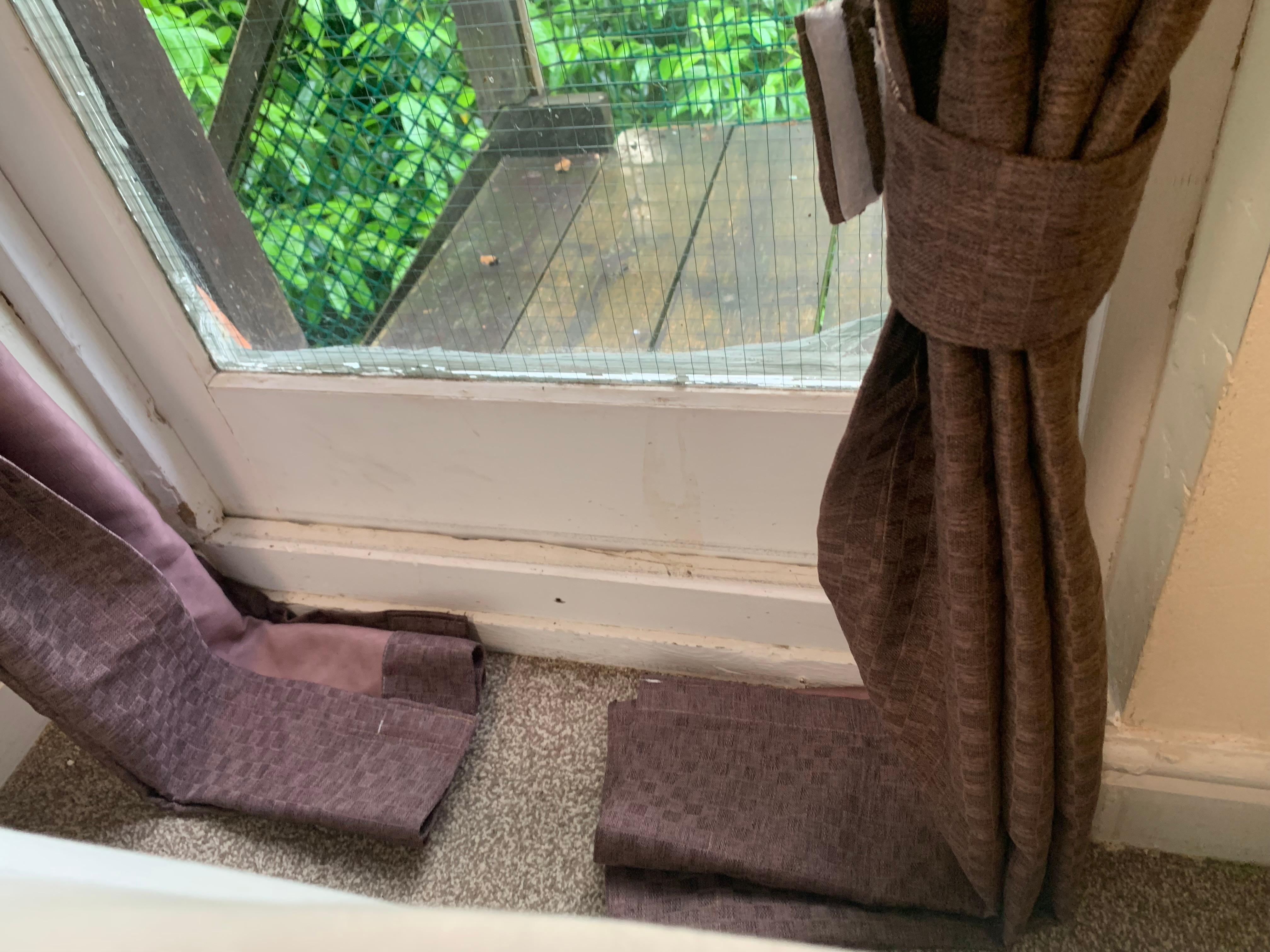 Oversized curtain on the floor - window area not clean