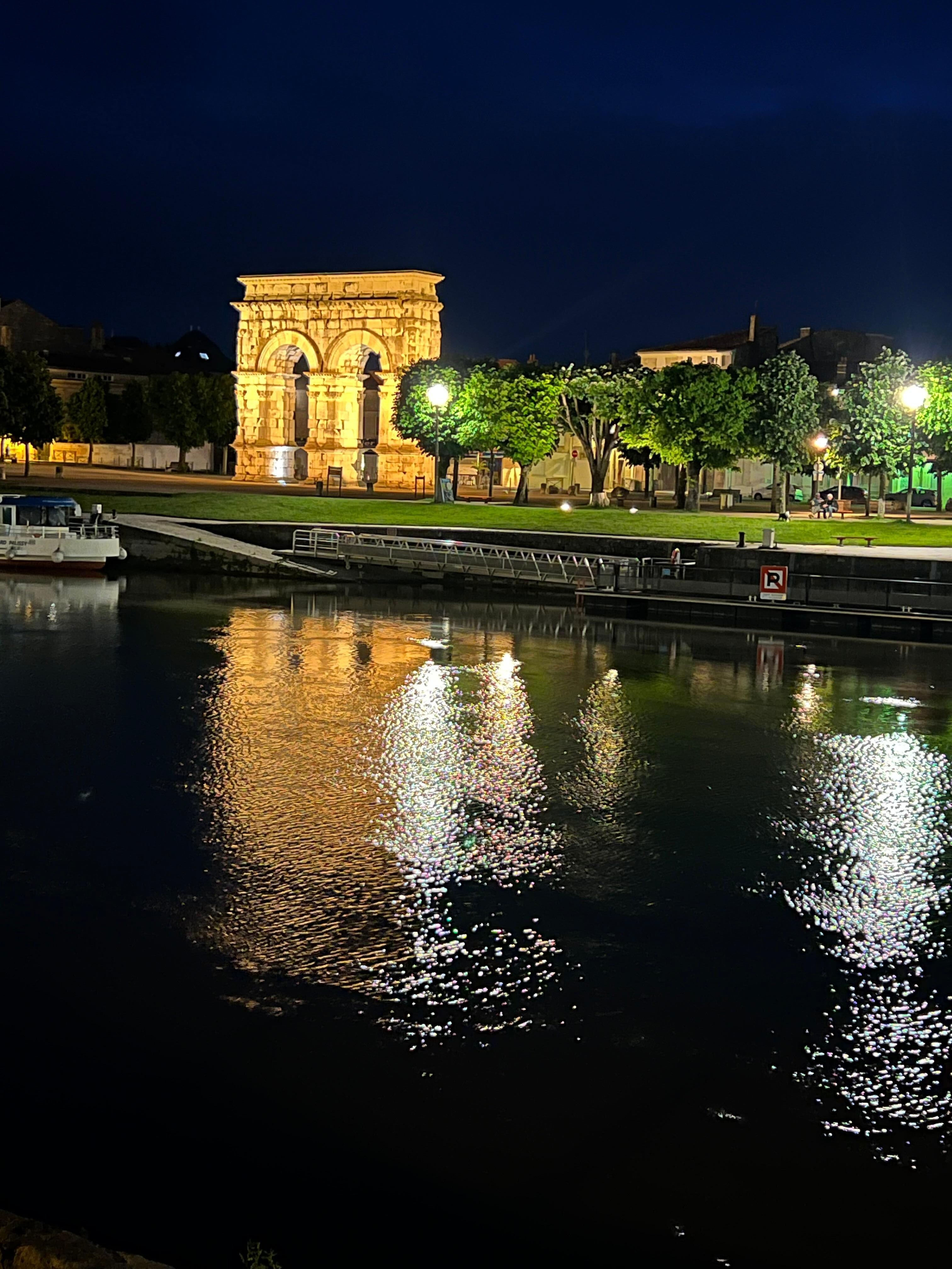 A picture of the Germanicus Arch from across the river at night