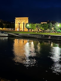 A picture of the Germanicus Arch from across the river at night