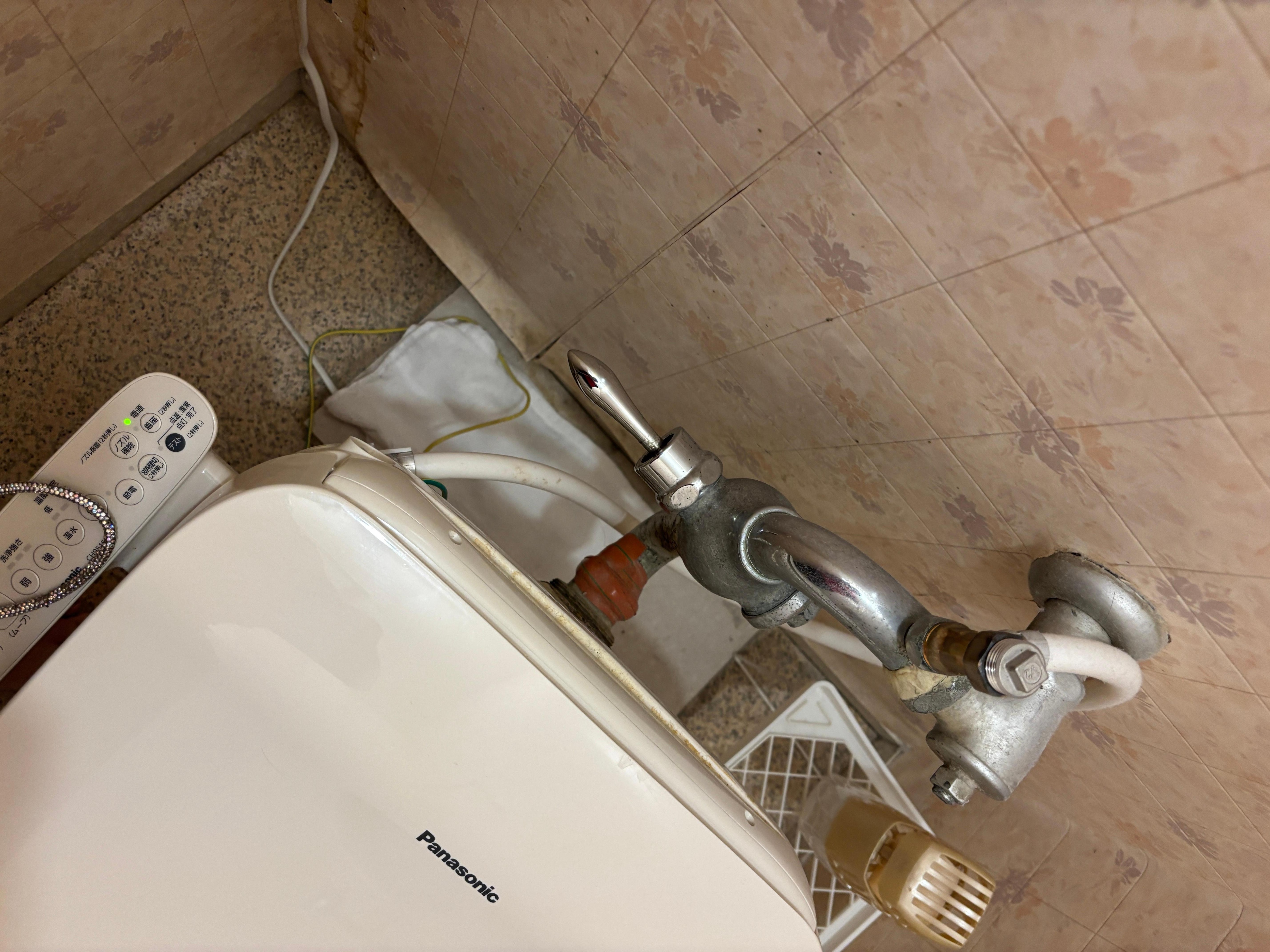 Leaking toilet that hotel placed a towel to absorb 