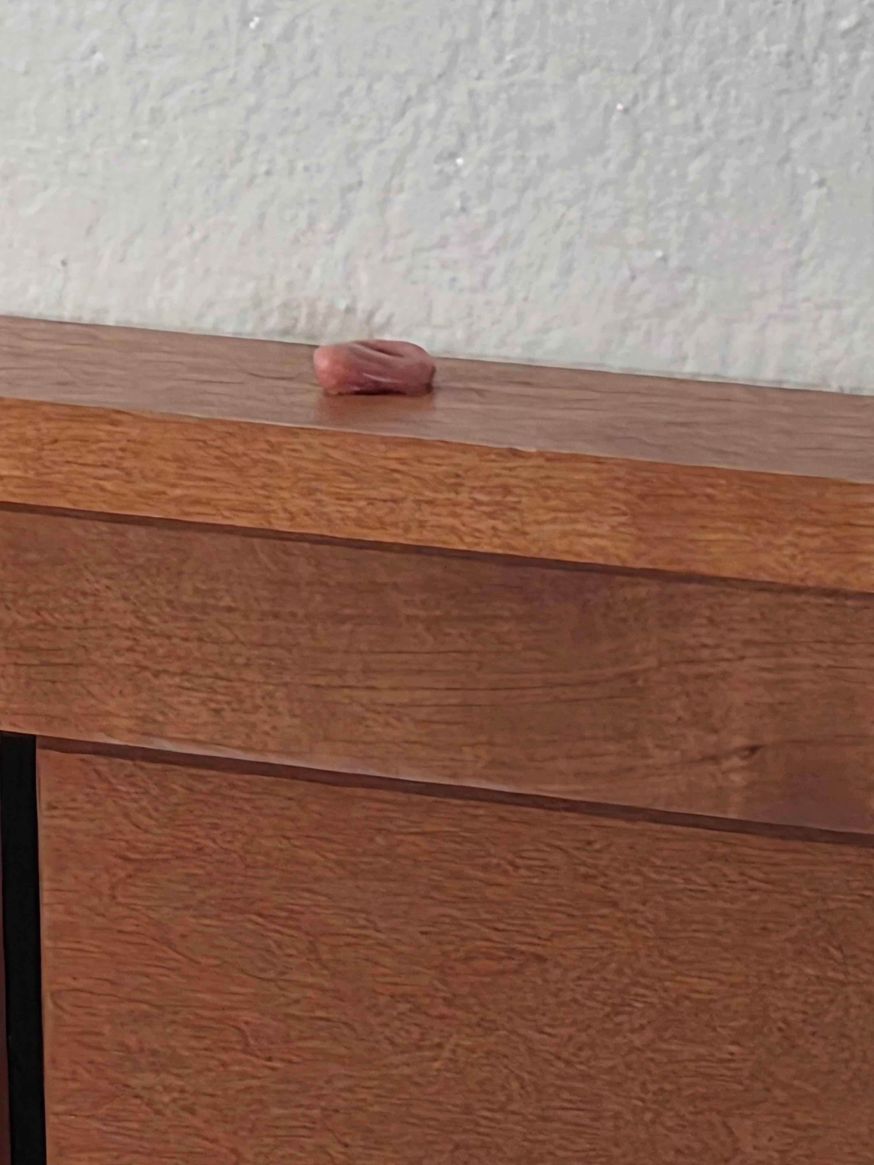 Chewed up gum on headboard