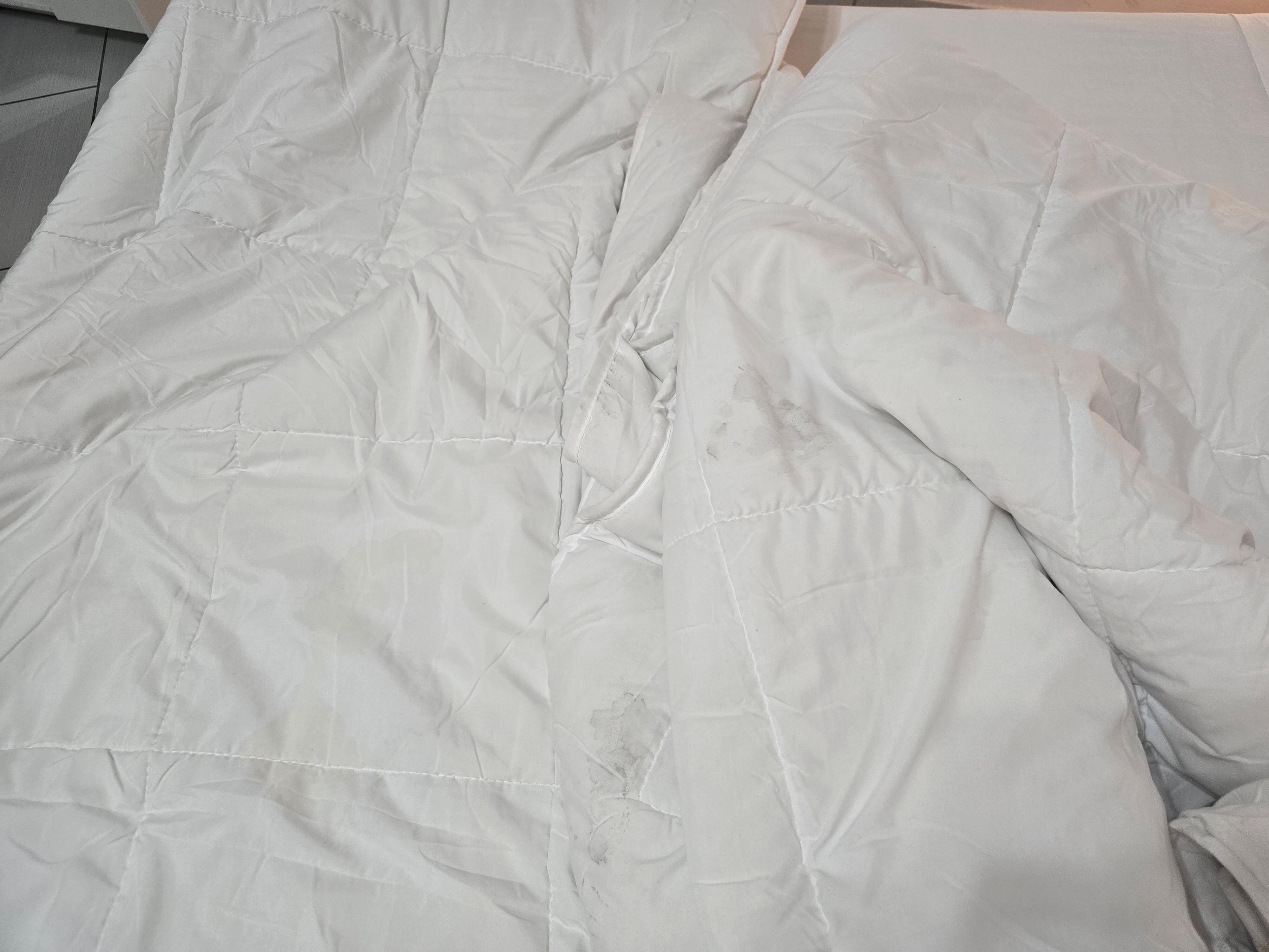 Lots of dirty blankets with makeup, blood and yellow stains. 