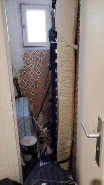 Closet outside our room with rollaway bed and what also looks like a futon.