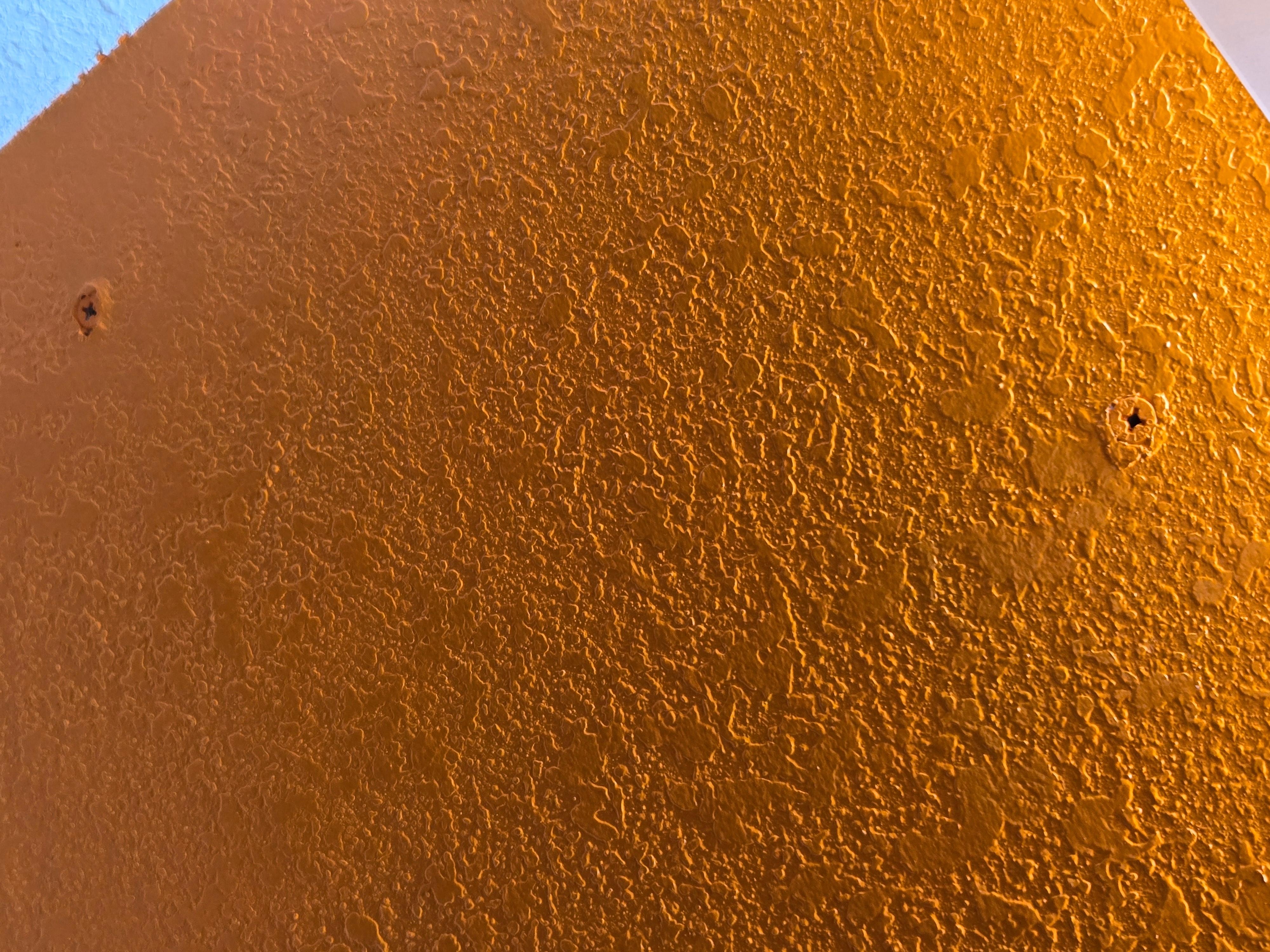 Exposed screws in wall