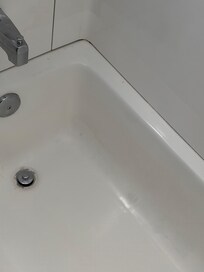 Hair and spots all over the dirty bath tub