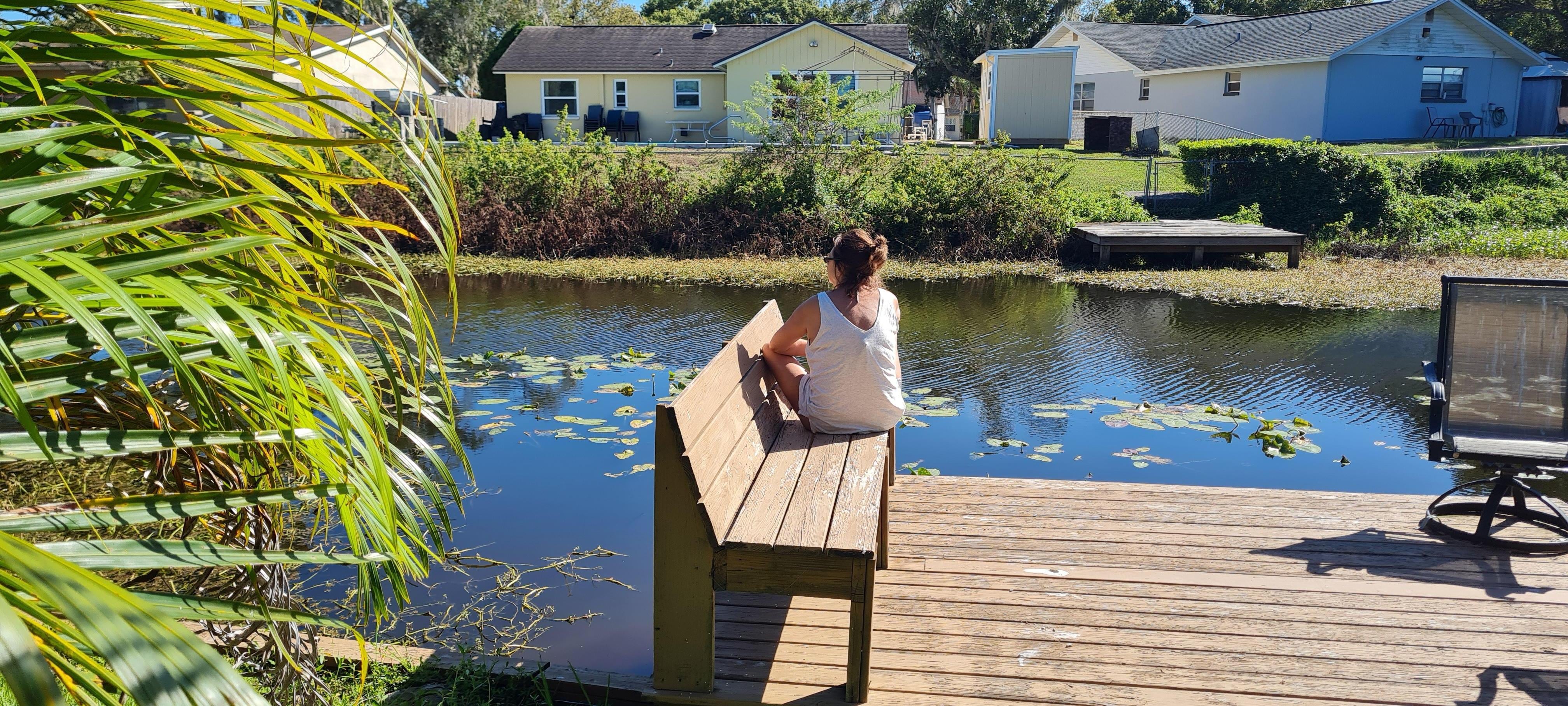 Sitting on the dock of the lake.