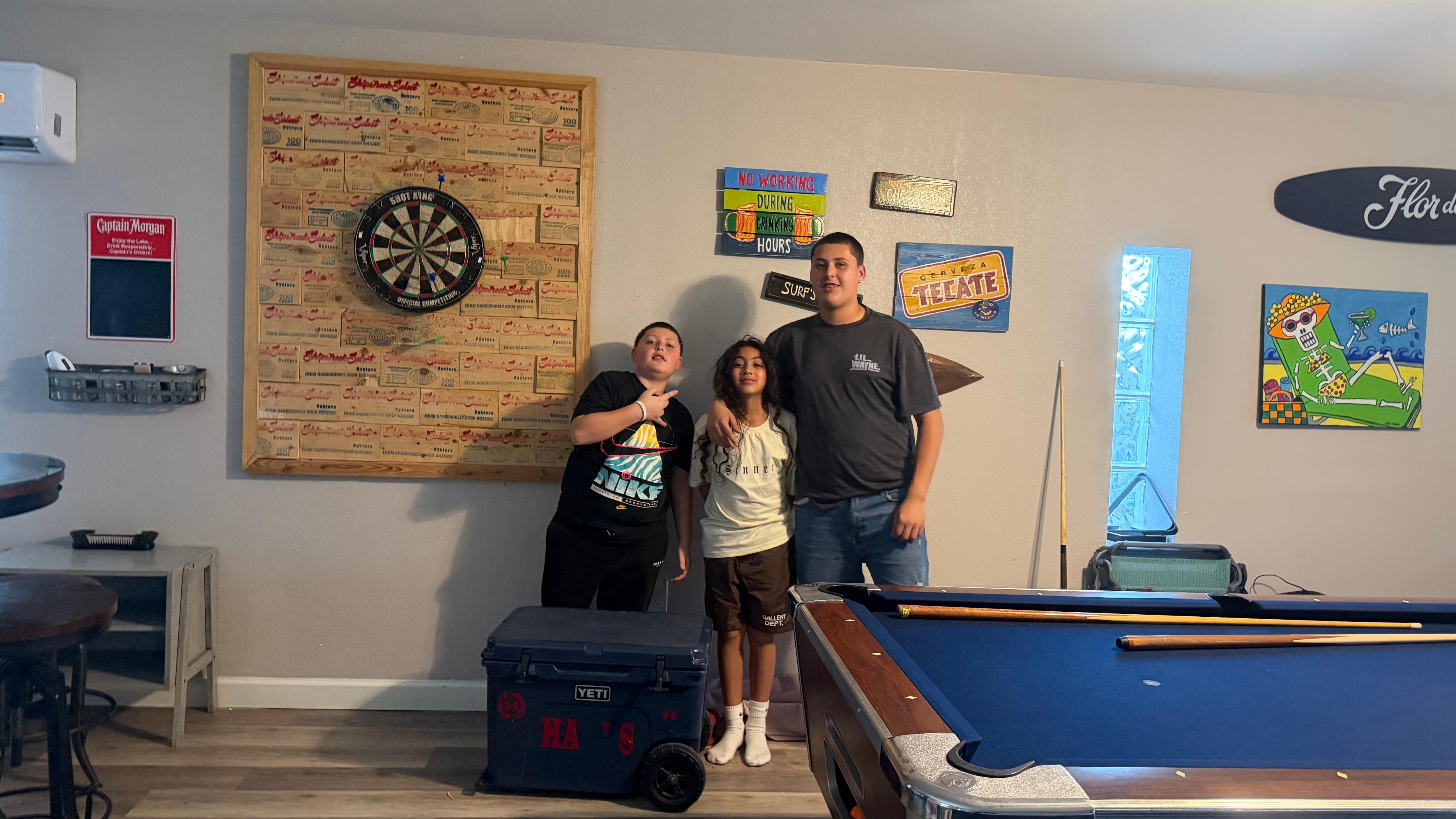 This was the entrance that had a game room feel with a table 2 refrigerators and ice machine with tv and half bath with a tv and couch great place for chill . 