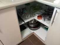 Open cupboard no doors. I did see a cockroach running in there