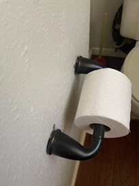 Toilet very wobbly and toilet paper holder coming off of wall