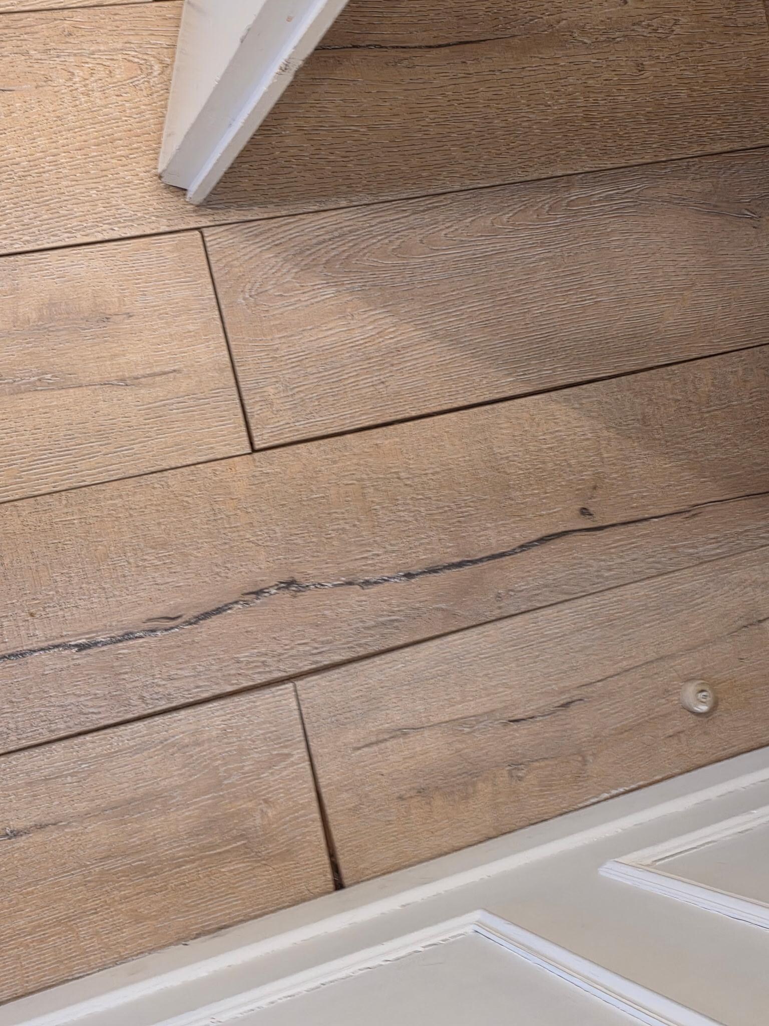The poorly installed floor boards.