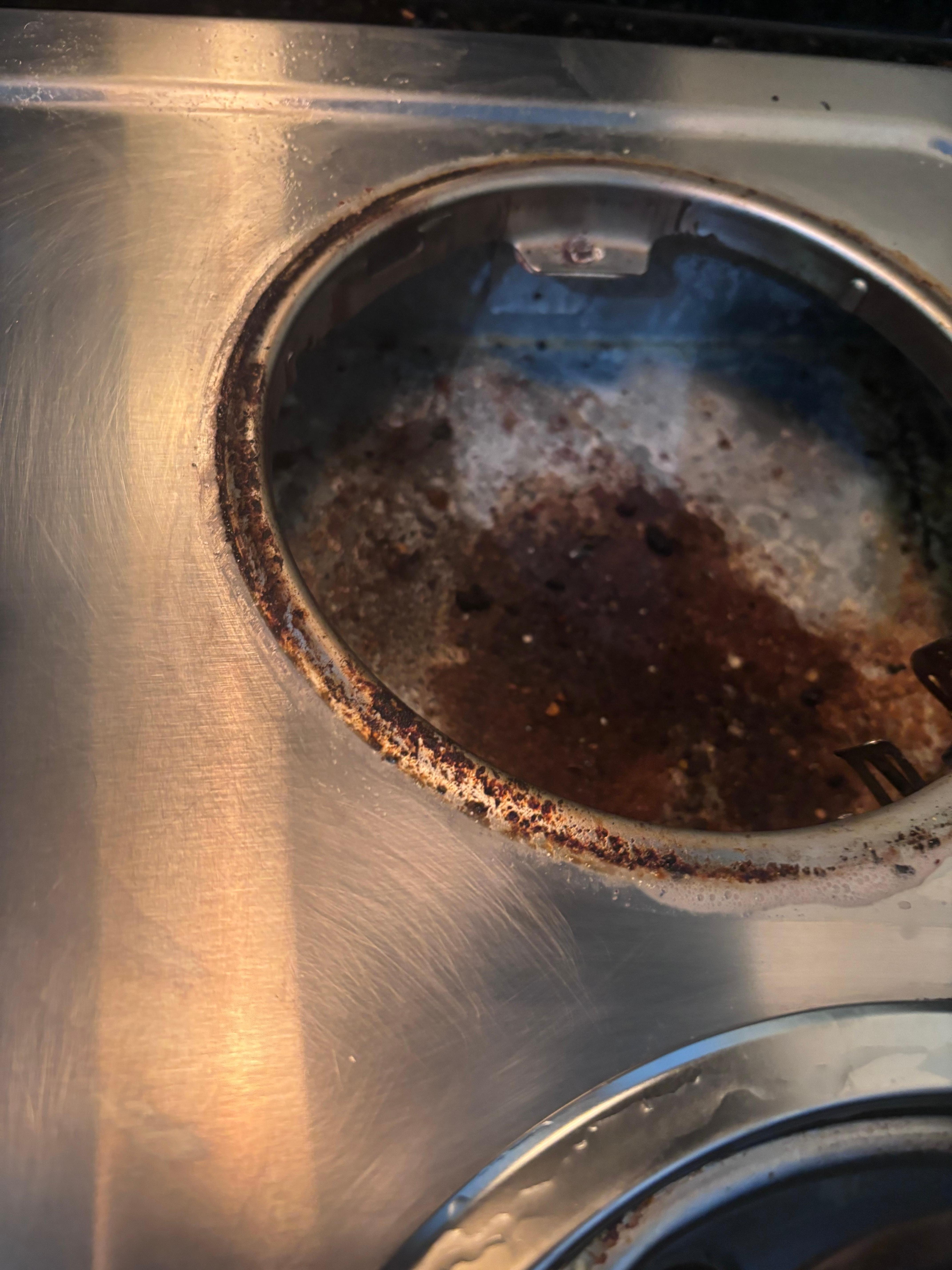 Incredibly filthy around and under the pan under the stove eye