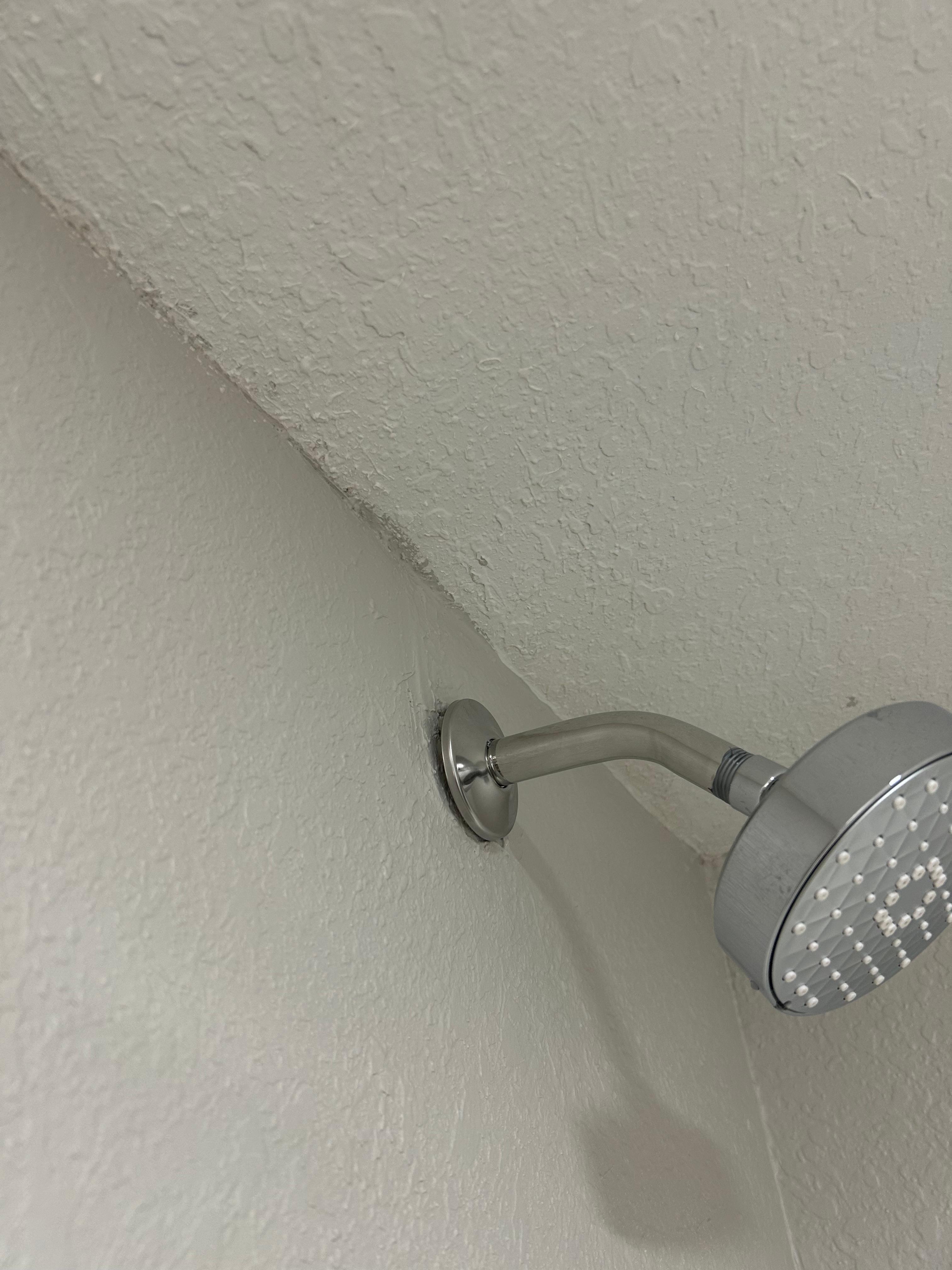 Showerhead moves in and out of the wall, you cannot adjust it