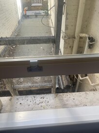 Ladder outside window (water pipe also visible)