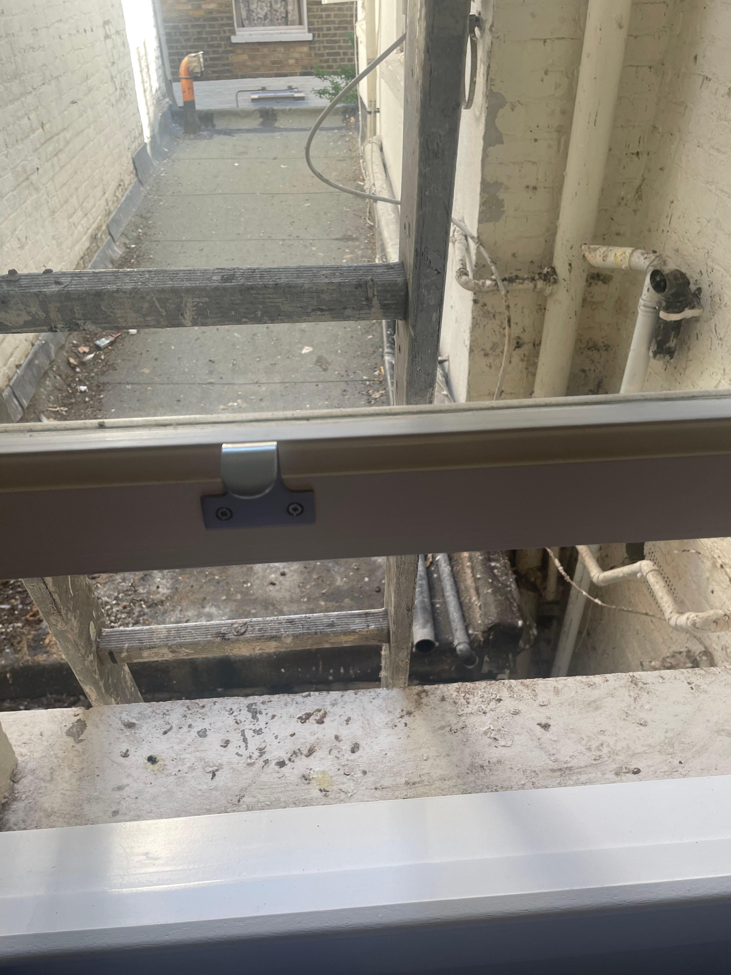 Ladder outside window (water pipe also visible)