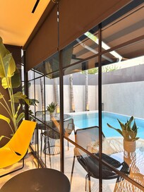 Reception area overlooking a small pool and some seating for breakfasts