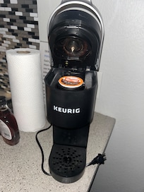 Broken Keurig with water still filling the drip tray
