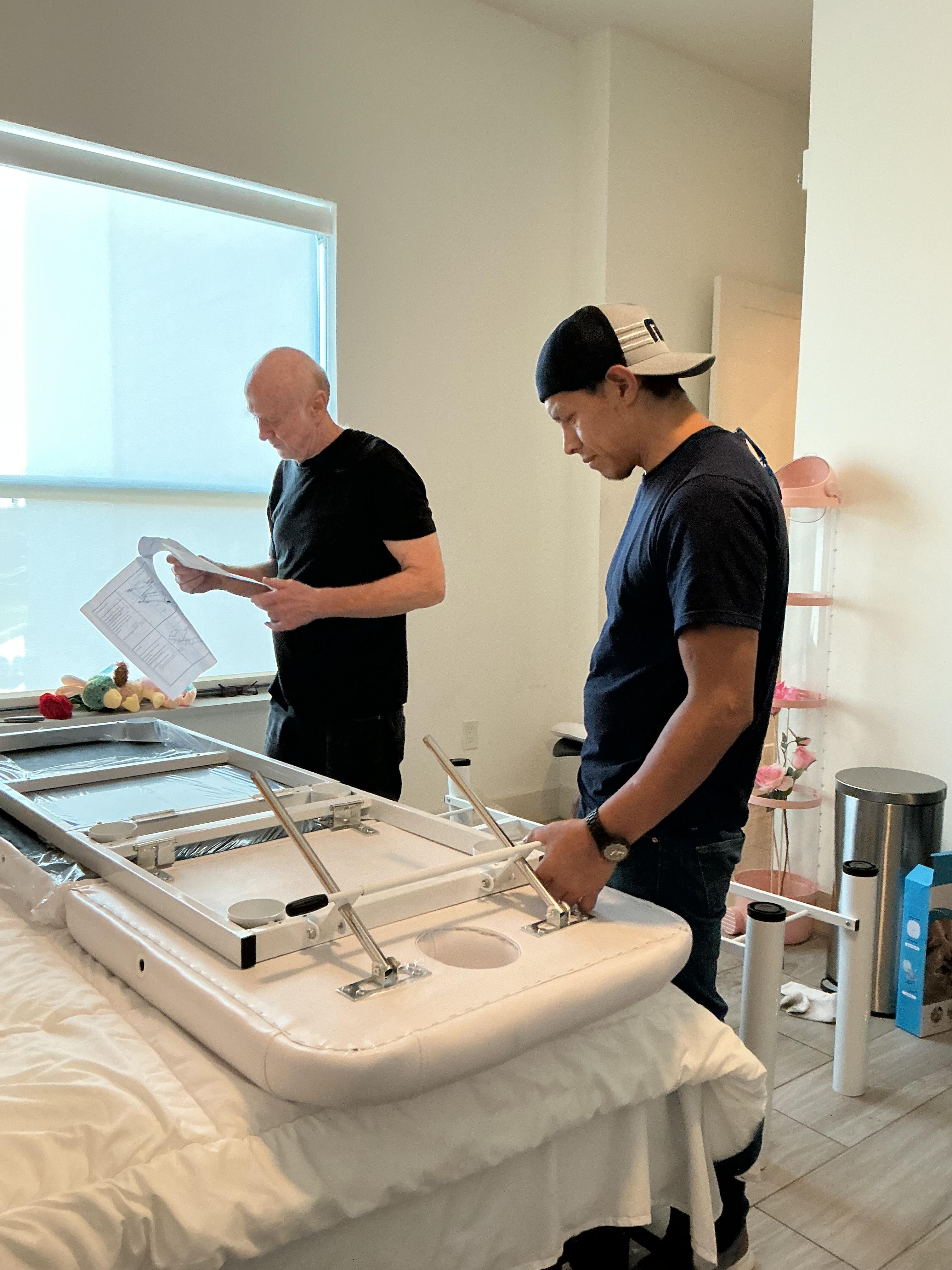 Putting together a massage table in the bedroom that I ordered from Tumu