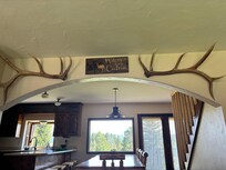 Looking from the living room into the dining room. Golf course in background.
