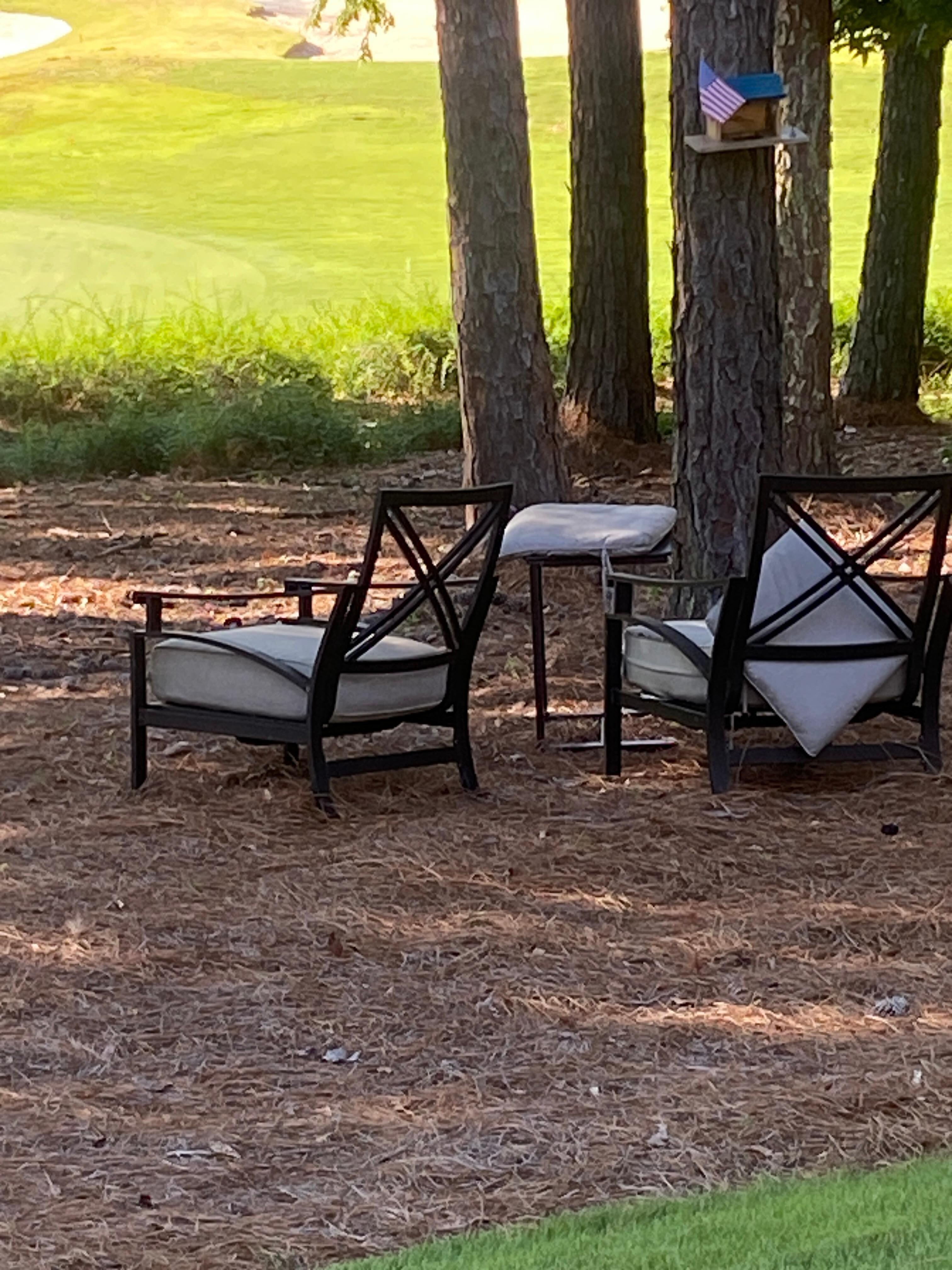Haphazard outdoor furniture placed beyond the fence