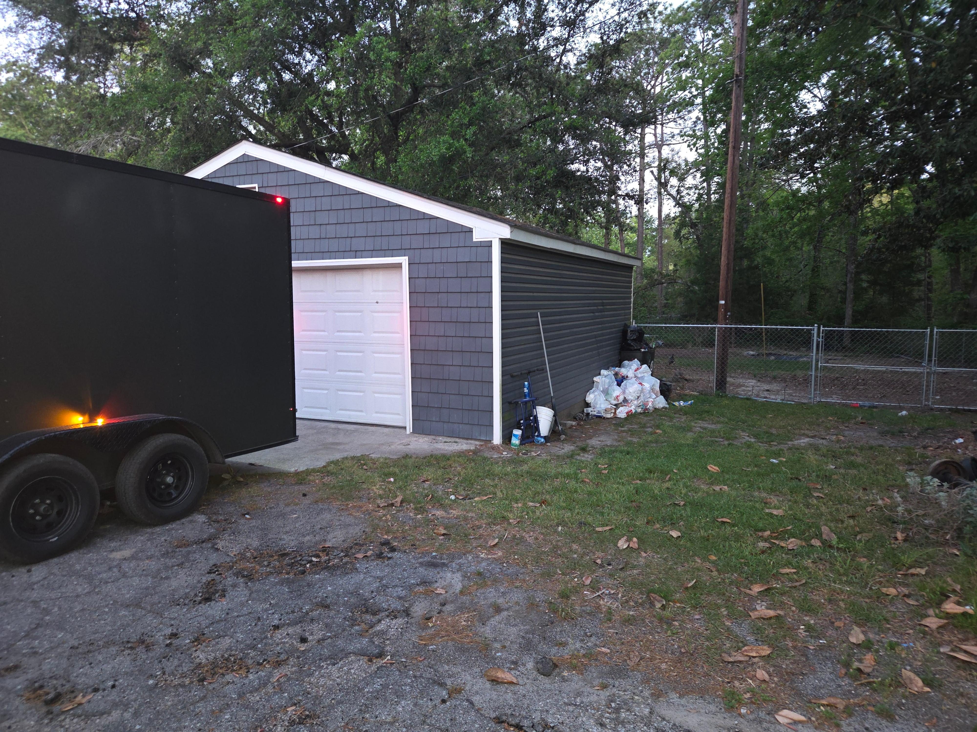 Trash piled up beside detached garage 