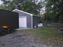 Trash piled up beside detached garage