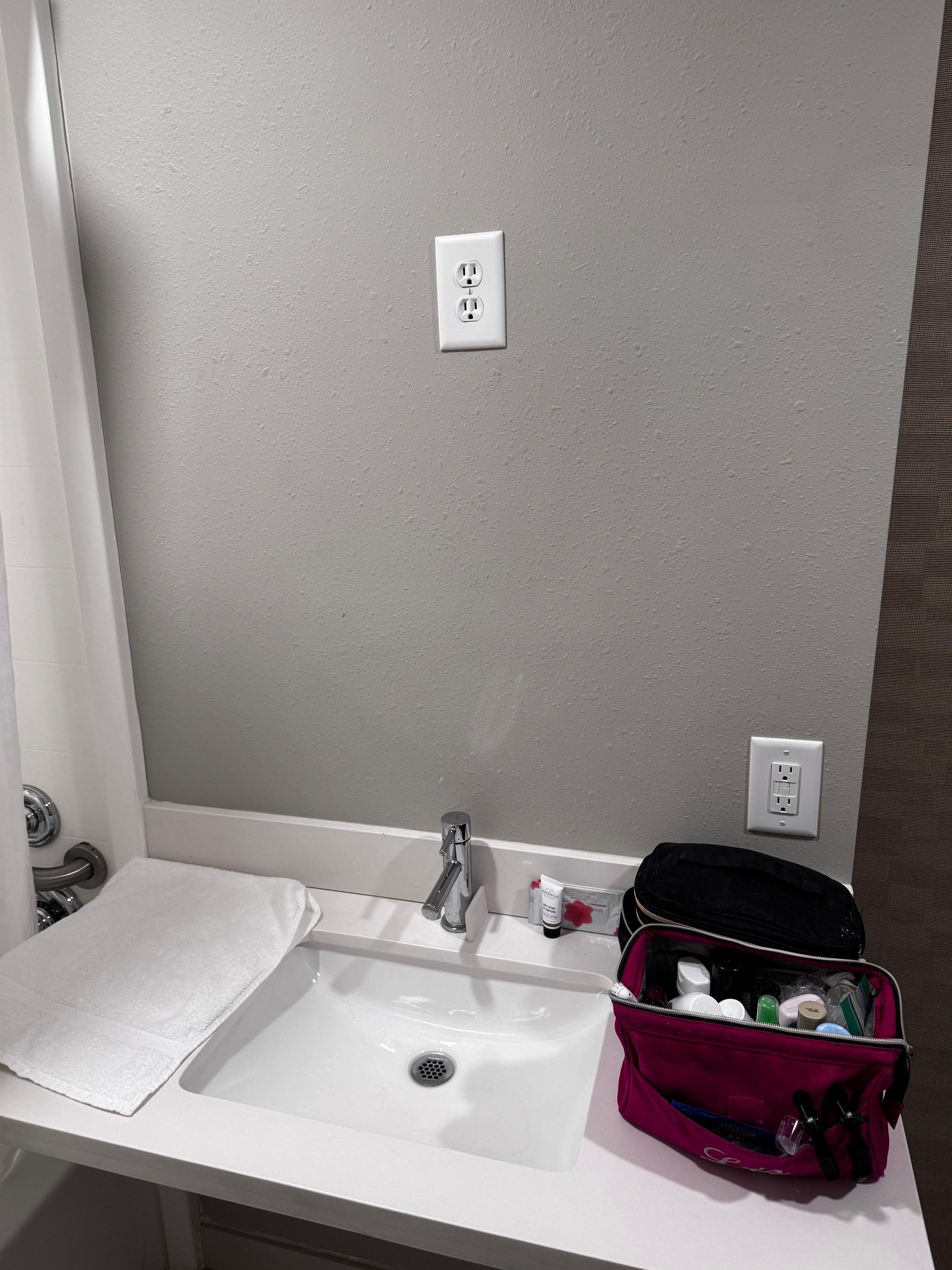 In place of a mirror, you get another electrical outlet up high where handicap people in wheelchairs cannot reach (handicap people being the reason given go us why that room does not need a mirror in the first place). 