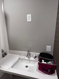 In place of a mirror, you get another electrical outlet up high where handicap people in wheelchairs cannot reach (handicap people being the reason given go us why that room does not need a mirror in the first place).