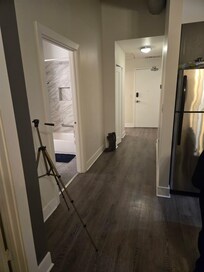 The hallway between the front of the apartment and the back.