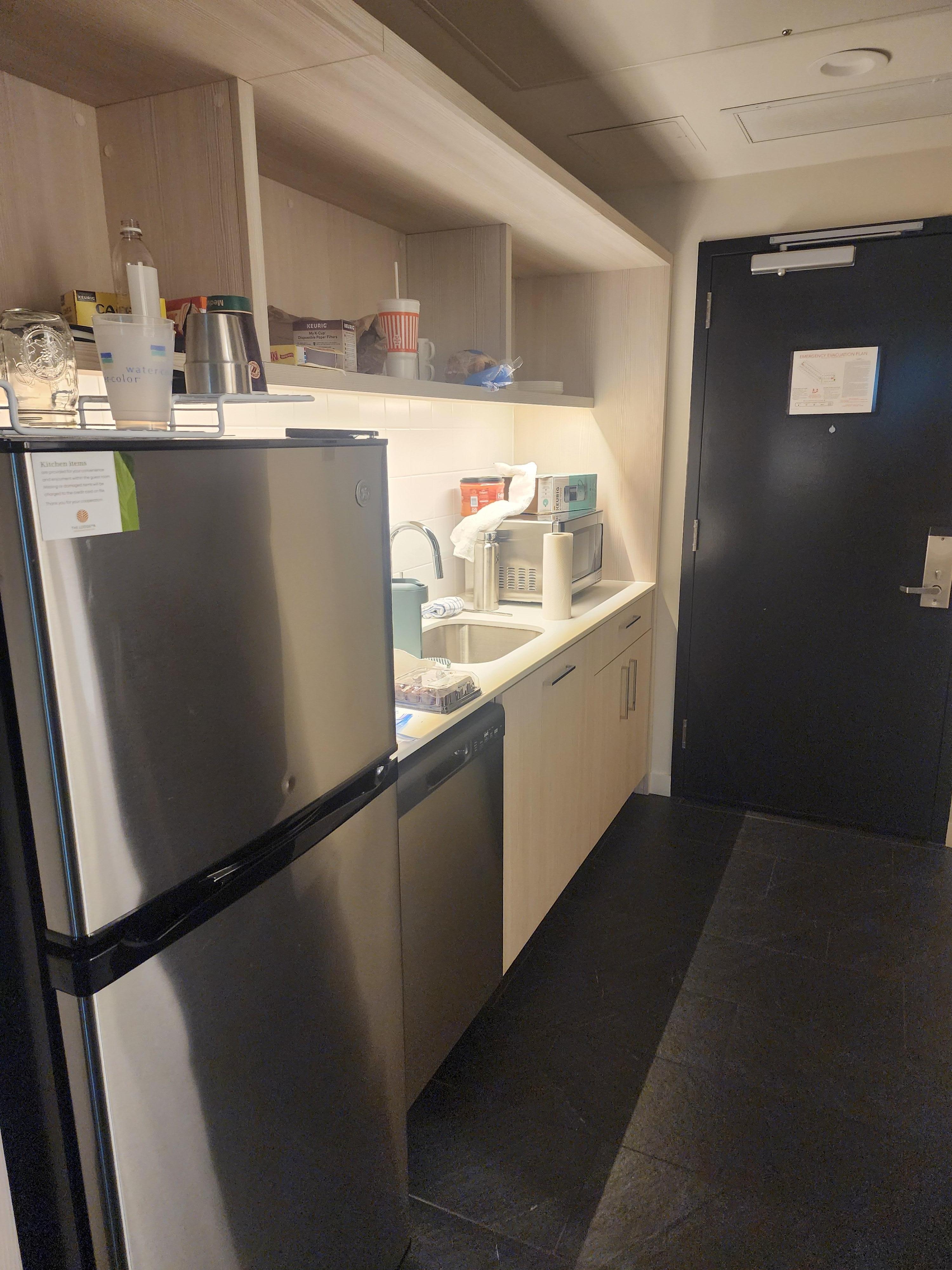 kitchen area - including full size fridge, and dishwasher