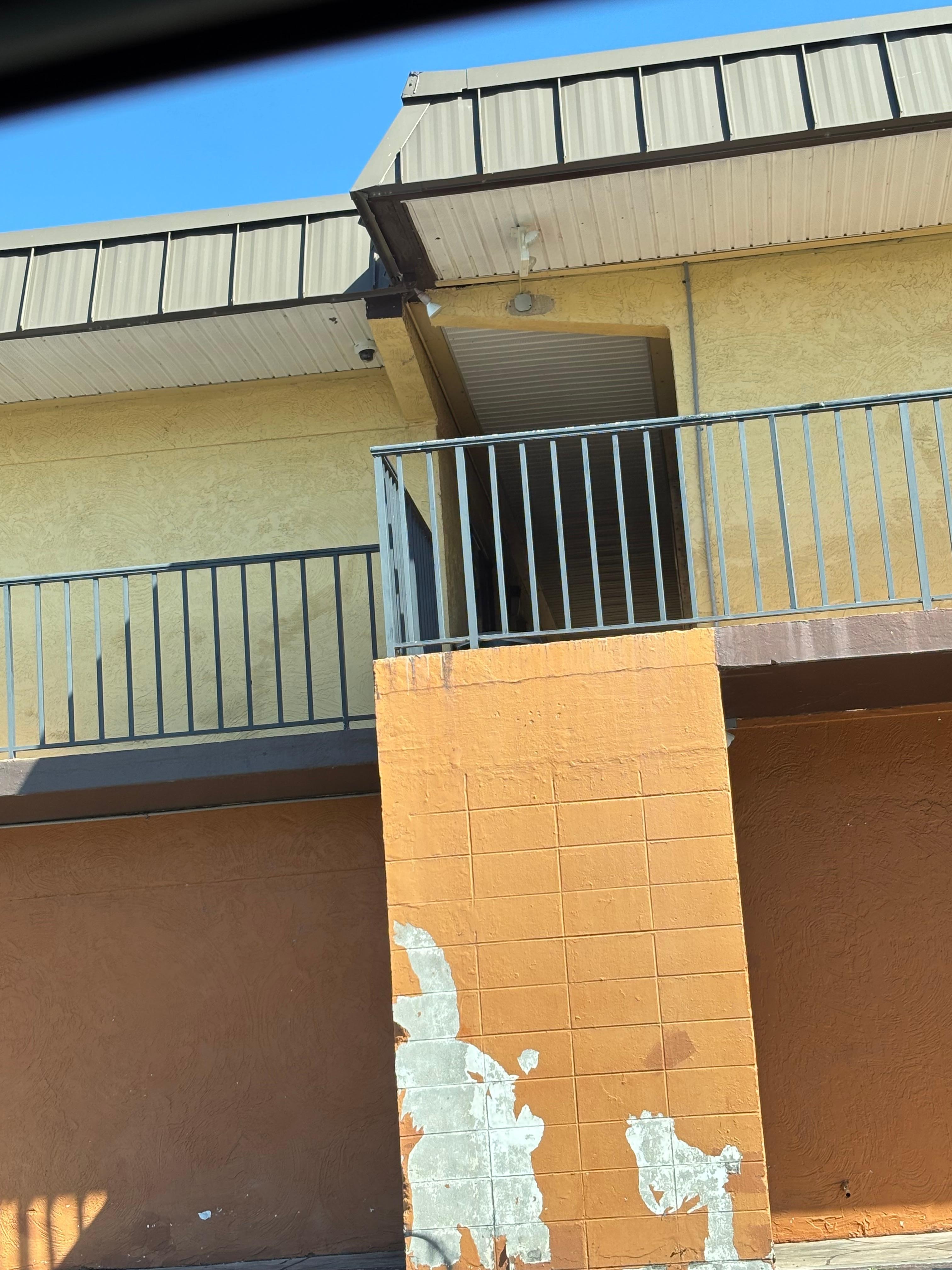 Dark hall where my room was. Wall in disrepair 