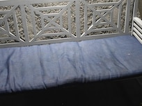 Bench in outdoor hallway appears unclean