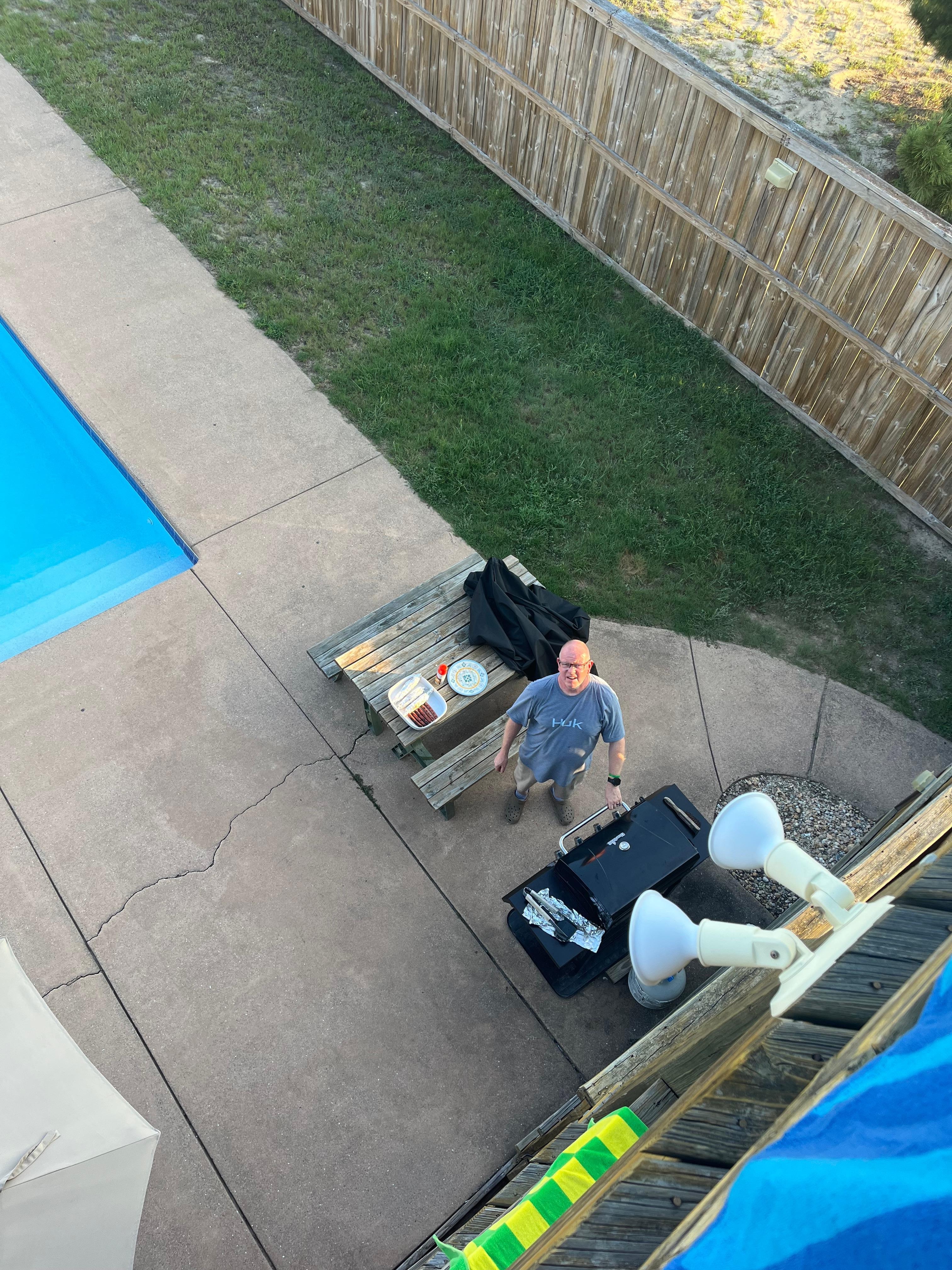 Grilling dinner poolside.