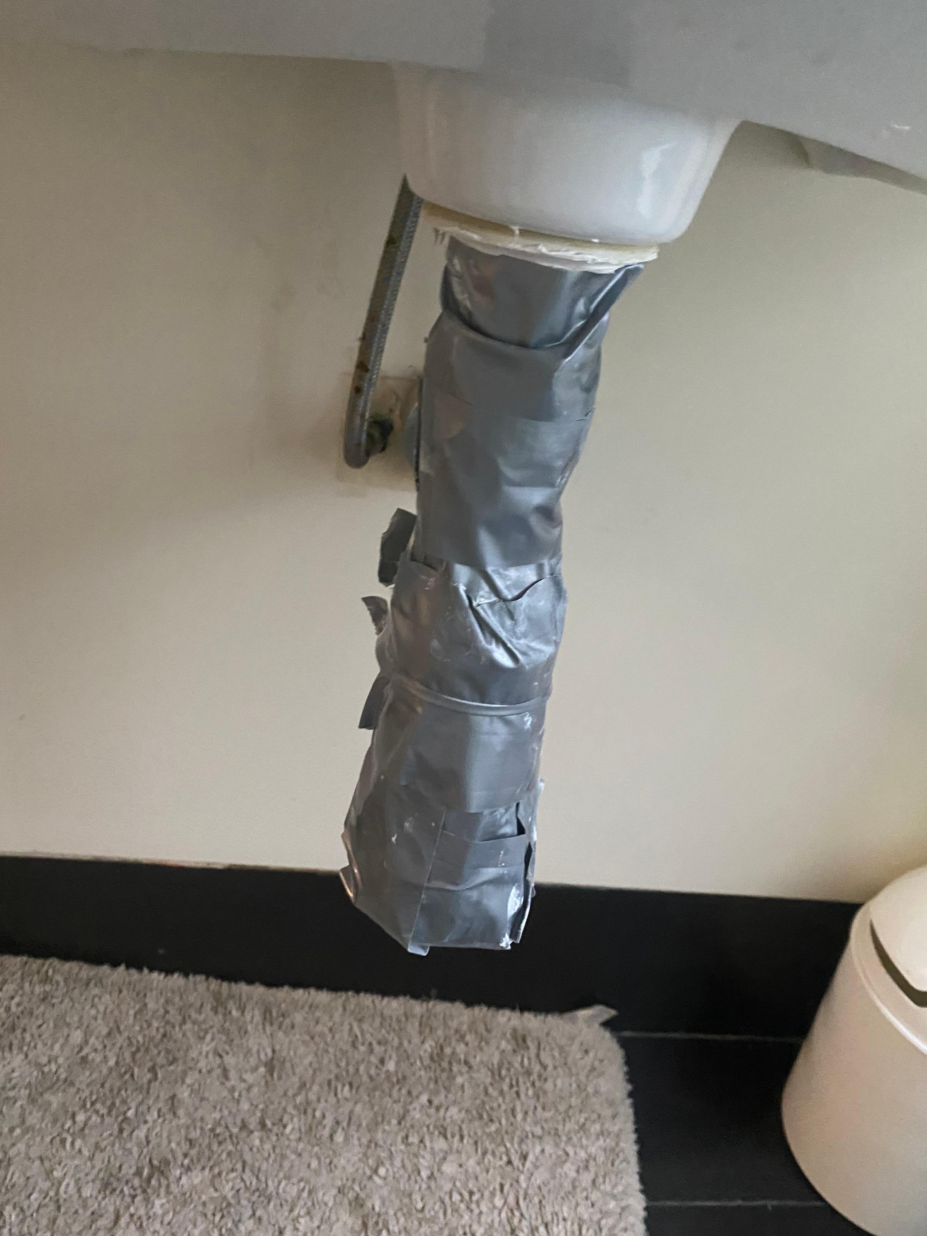 Below the hand basin in the bathroom.