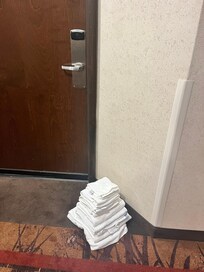 Clean laundry stacked on dirty carpet, left for several dsys