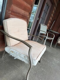 Ripped chair pads on old rusted patio chairs