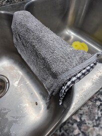 Dirty kitchen towels left in sink