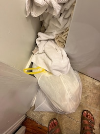Put wet smelly sheets that were left in the washer in trash bag